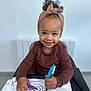 Rym participe au concours pour gagner de l'argent avec cette photo : art, brown_clothing, child, creative, curly_hair, cute, drawing, happy, headband, highchair, indoor, markers, paper, person, playful, portrait, scribbles, smiling, toddler, young_child