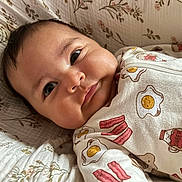 Catalina joined the competition — help win amazing prizes! baby, bacon, bed, breakfast_theme, cheeks, clothing, cute, egg, expression, face, floral, indoors, infant, lying_down, onesie, pattern, portrait, quilt, syrup, waffle
