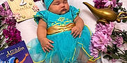 Catalina is registered to the contest to win money with this photo: aladdin, baby, blue_dress, celebration, cute, flowers, gold_belt, headband, infant, laying_down, magic_lamp, peaceful, pink_flowers, portrait, purple_flowers, sleeping, soft_fabric, storybook, tulle_skirt, two_months
