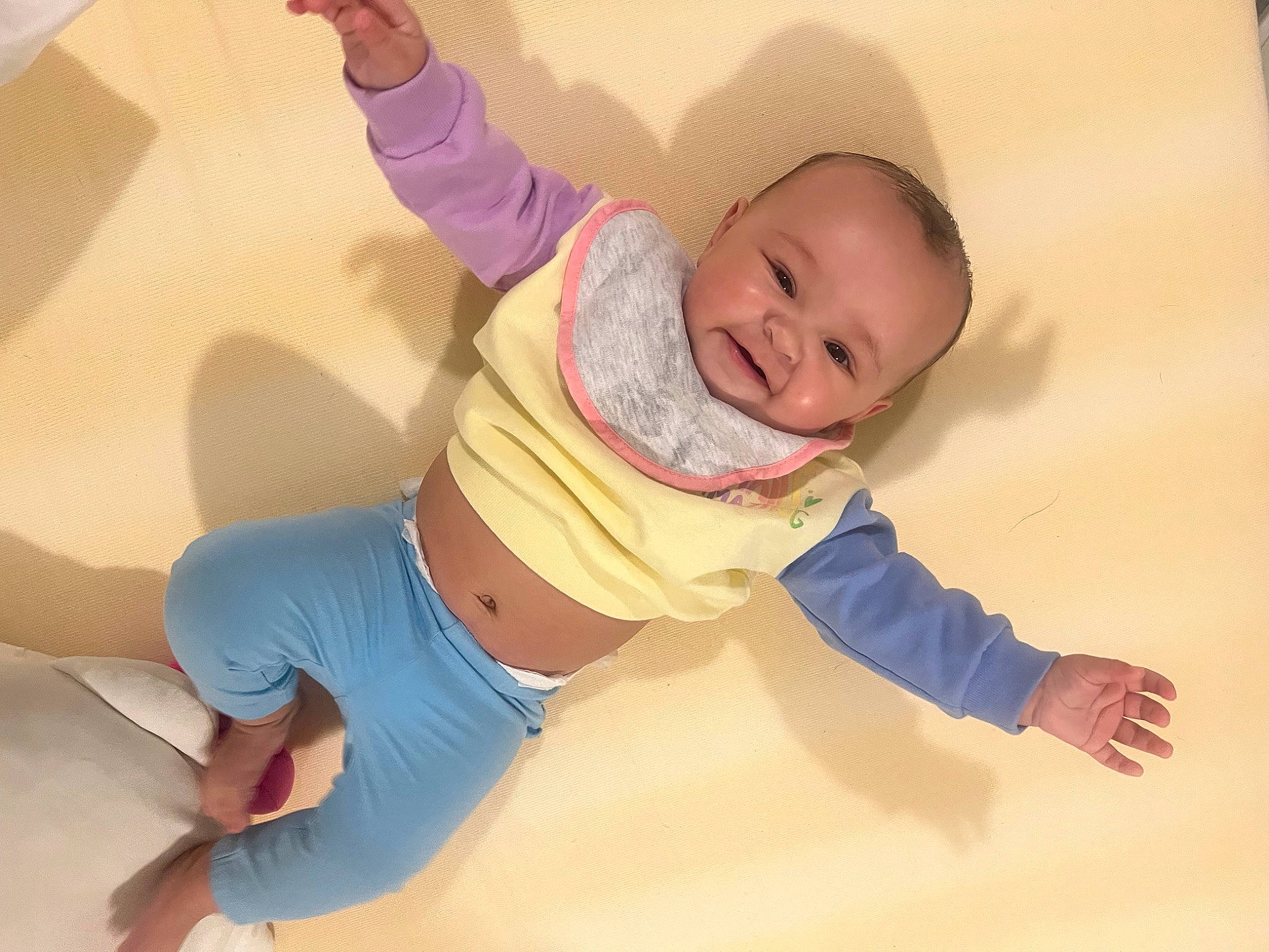 Penelope is registered to the contest to win money with this photo: baby, baby_toddler_clothing, child, comfort, elbow, floor, flooring, fun, gesture, happy, human_leg, joint, knee, leg, person, sleeve, smile, t_shirt, thigh, toddler