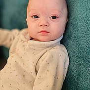 Priya participe au concours pour gagner de l'argent avec cette photo : baby, infant, face, eyes, clothing, blanket, soft, cute, portrait, child, young, person, indoors, sitting, warm, expressionless, cozy, pale, head, skin
