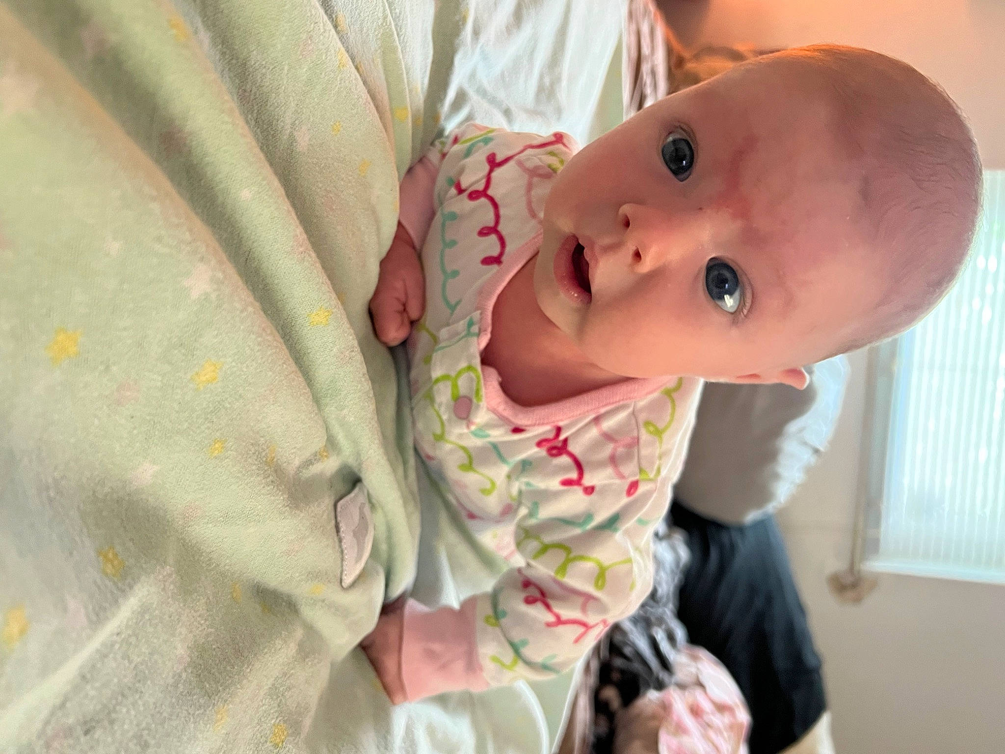 Raelynn is registered to the contest to win money with this photo: baby, baby_products, baby_safety, baby_toddler_clothing, bed, cheek, child, comfort, finger, happy, infant_bed, linens, lip, nose, person, room, skin, sleeve, smile, surprise
