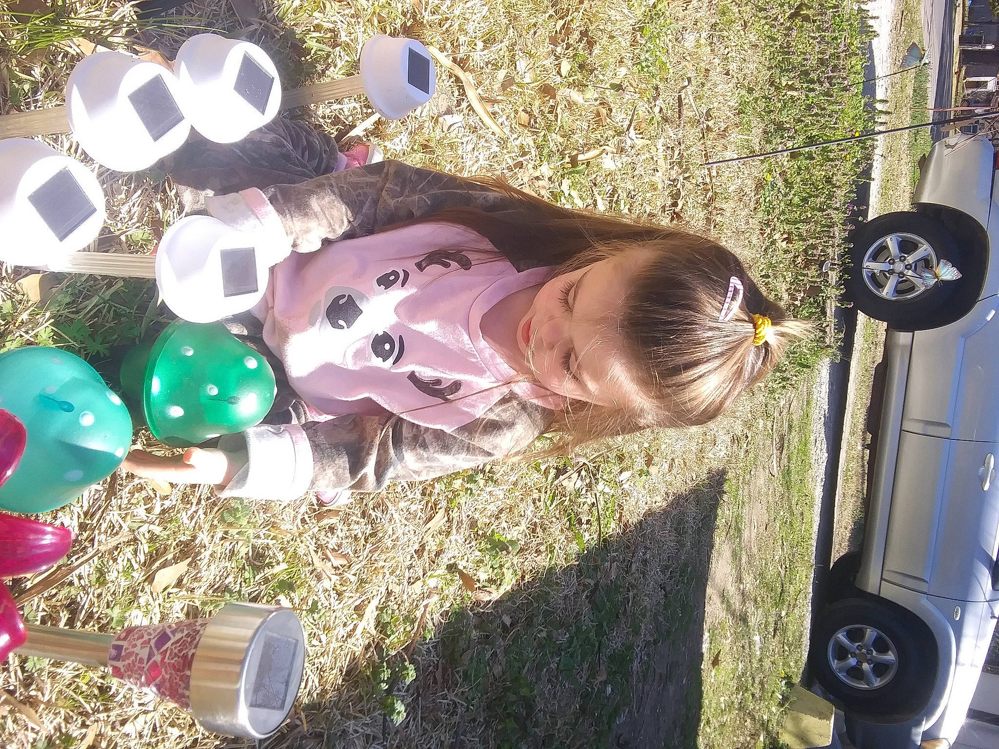 Kayla joined the competition — help win amazing prizes! automotive_exterior, automotive_lighting, automotive_tire, bumper, car, child, event, family_car, fender, fun, grass, leisure, light, party_supply, person, tire, toddler, toy, tree, vehicle_door