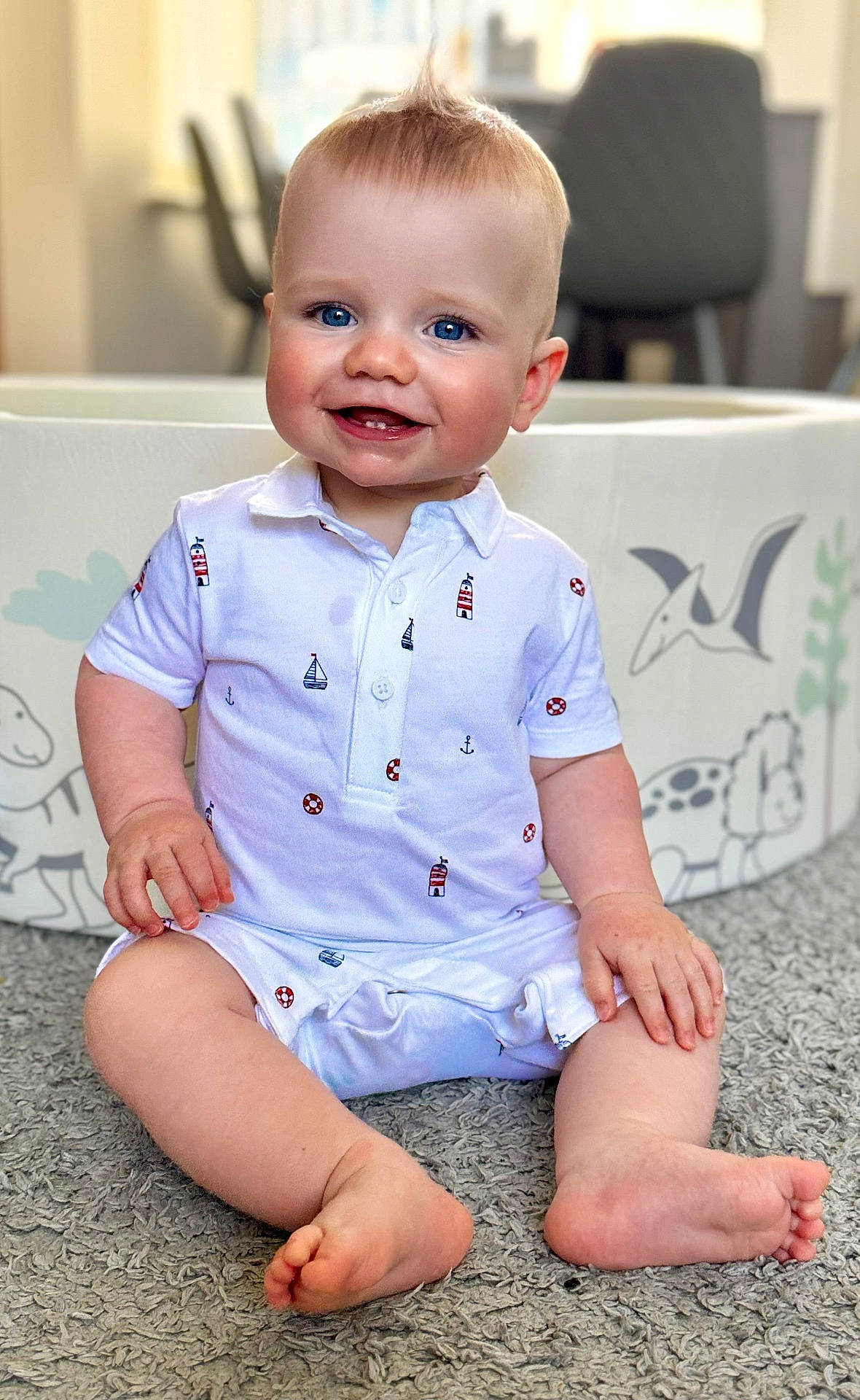 baby, babylaughing, bodypart, clothing, dress, face, finger, hand, happy, head, jeans, pants, person, photography, portrait, shirt, shorts, sitting, sleeve, smile