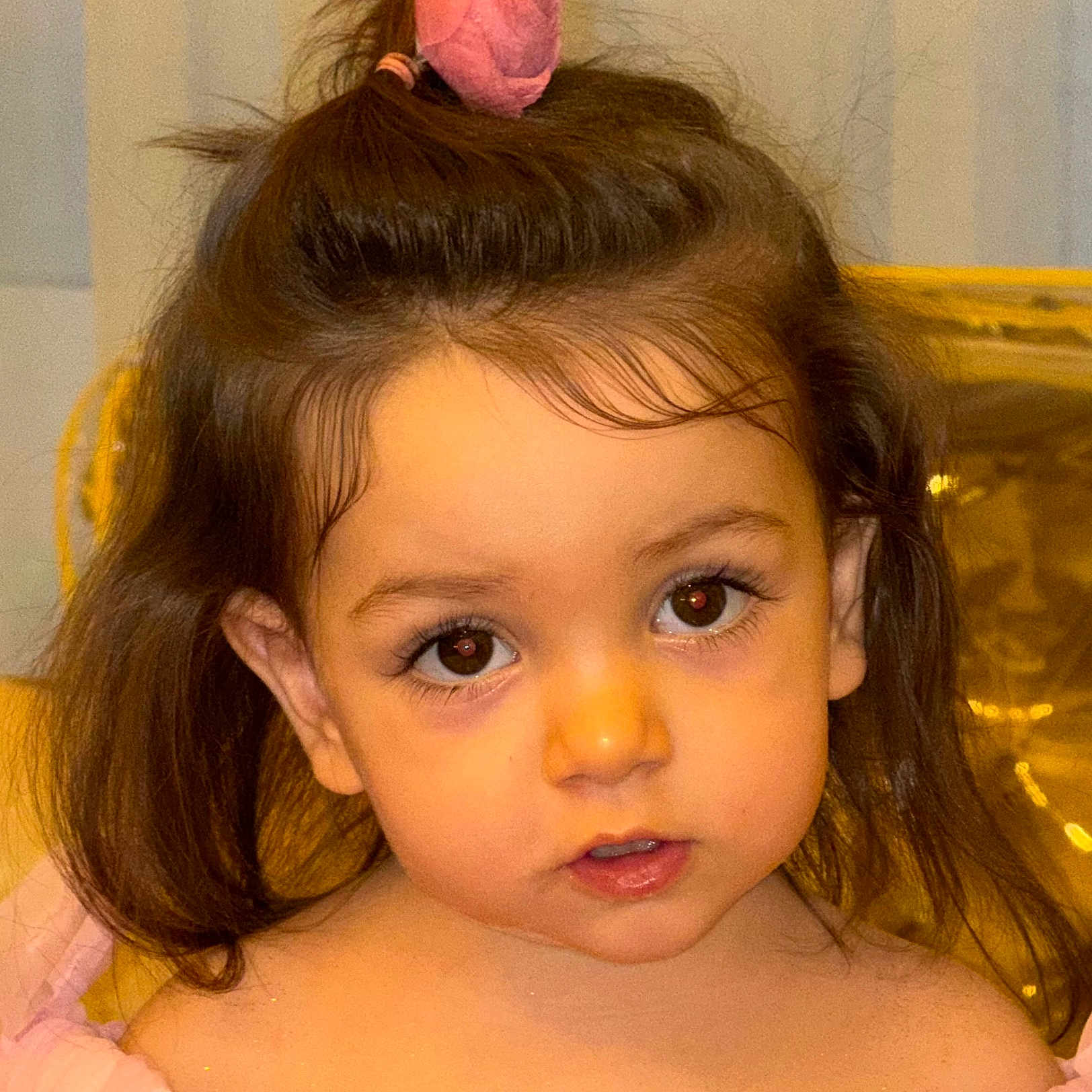 Rose joined the competition — help win amazing prizes! child, toddler, face, portrait, brown_eyes, hair_accessory, pink_clothing, curly_hair, cute, indoor, young_child, person, closeup, expression, innocent, baby, eyelashes, soft_light, headshot, beauty