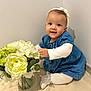 Héléna a rejoint le concours — aidez-le/la à gagner de superbes lots ! baby, child, flower, vase, blue_dress, white_tights, headband, smiling, sitting, indoor, curious, cute, portrait, infant, young_child, skin, hand, face, white_background, decor