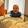 Héléna a rejoint le concours — aidez-le/la à gagner de superbes lots ! baby, child, mirror, reflection, headband, denim_dress, smile, happy, curious, indoor, blanket, soft, hands, face, portrait, crawling, person, cute, infant, play