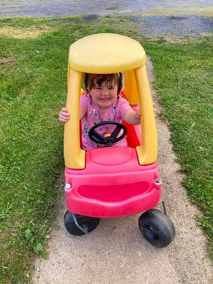 Nevayh is registered to the contest to win money with this photo: baby, baby_carriage, baby_products, baby_toddler_clothing, bumper, fun, grass, happy, joy, leisure, magenta, motor_vehicle, person, plant, recreation, riding_toy, sitting, smile, tire, toddler