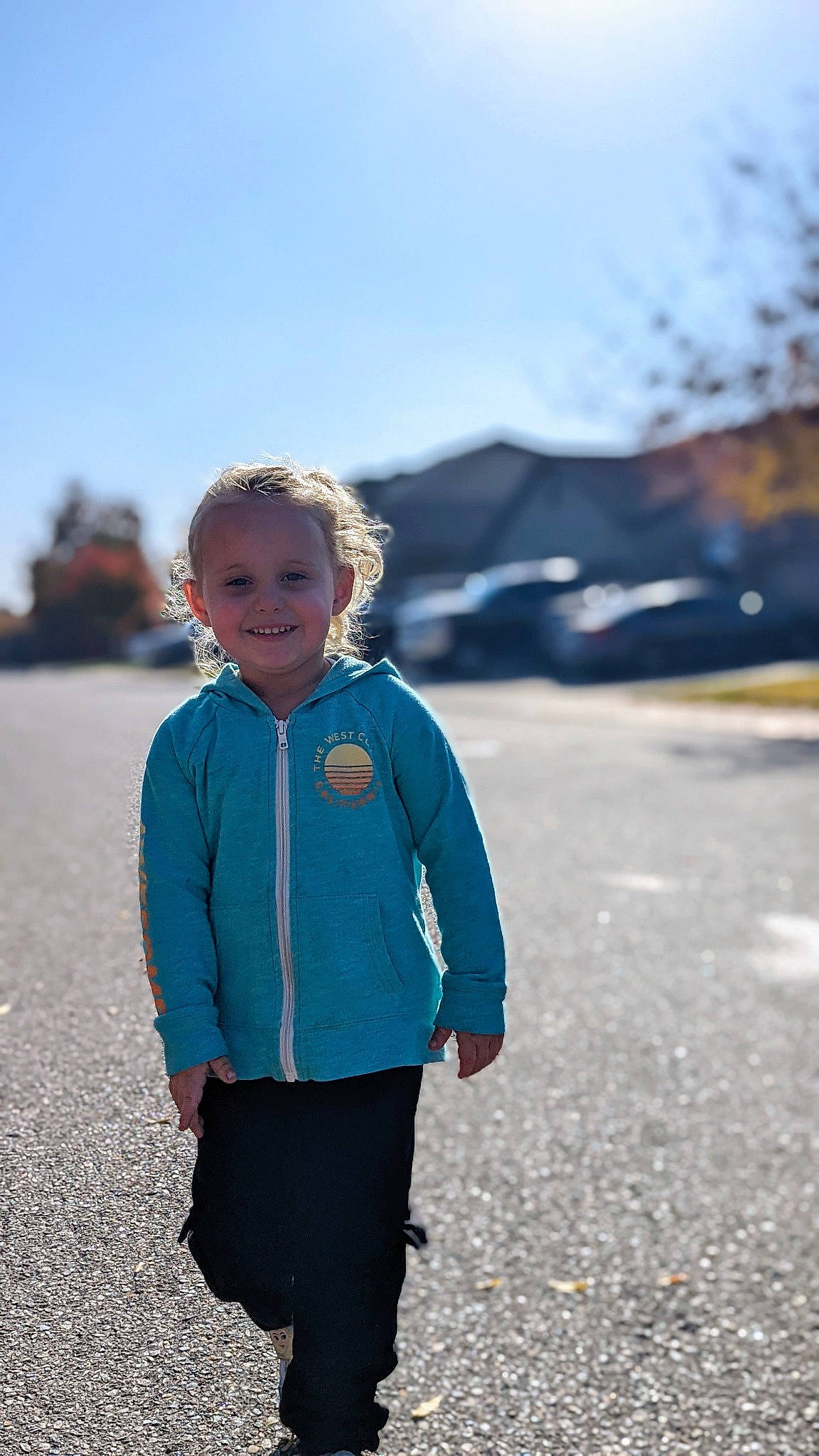 Wendy is registered to the contest to win money with this photo: asphalt, denim, electric_blue, fun, grass, happy, joy, landscape, leisure, pattern, people_in_nature, person, plant, recreation, road, sky, sleeve, smile, t_shirt, toddler