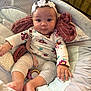 baby, infant, headband, flower, padded_seat, blanket, cushion, clothing, long_sleeve, leggings, indoor, face, child, cute, expression, hand, foot, comfort, soft, seated