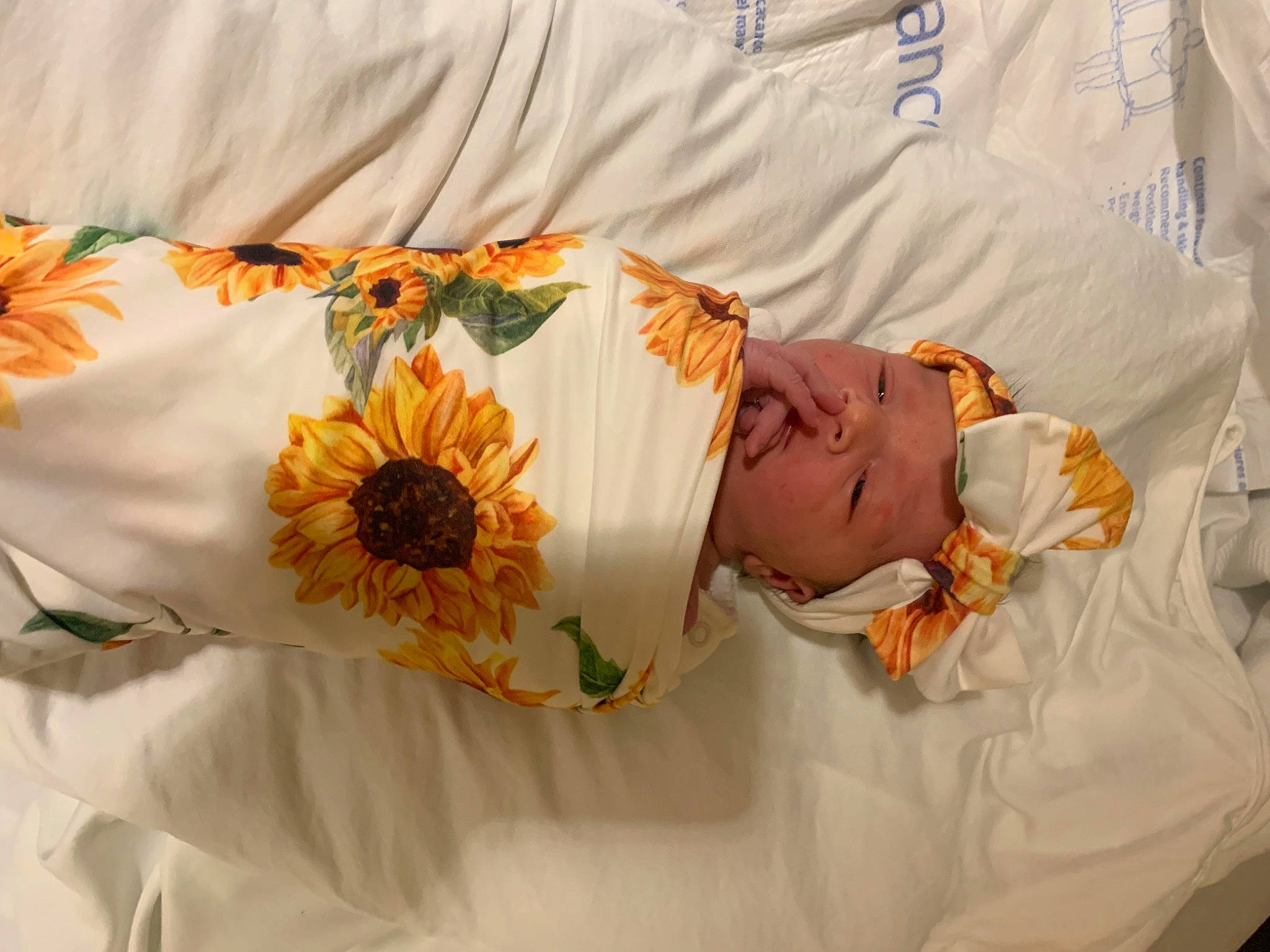 Kinsley joined the competition — help win amazing prizes! baby, baby_toddler_clothing, bouquet, comfort, cut_flowers, event, flower, flower_arranging, hand, linens, orange, pattern, peach, person, petal, plant, product, rose, sleeve, textile