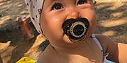 Soléya participe au concours pour gagner de l'argent avec cette photo : baby, pacifier, headband, child, outdoor, sunlight, tree, stroller, necklace, summer_clothing, floral_pattern, skin, face, eyes, cute, infant, nature, ground, shade, portrait