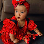 Soléya a rejoint le concours — aidez-le/la à gagner de superbes lots ! baby, child, red_dress, polka_dot, headband, bow, shoes, floor, indoor, curious, sitting, cute, bracelet, black, frills, portrait, fashion, accessory, couch, infant