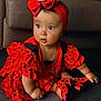 baby, child, red_dress, polka_dot, headband, bow, shoes, floor, indoor, curious, sitting, cute, bracelet, black, frills, portrait, fashion, accessory, couch, infant