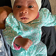 Aniyrah Scott joined the competition — help win amazing prizes! baby, infant, child, onesie, headwrap, bow, patterned_clothing, mint_green, pink, hand, face, eyes, carpet, person, holding, cute, newborn, indoor, portrait, cozy