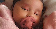 Selena Rosado is registered to the contest to win money with this photo: baby, bedding, blanket, bows, closed_eyes, cozy, cute, face, hair, indoors, infant, nursery, pacifier, peaceful, photography, pink, portrait, sleeping, soft_texture, teddy_bear