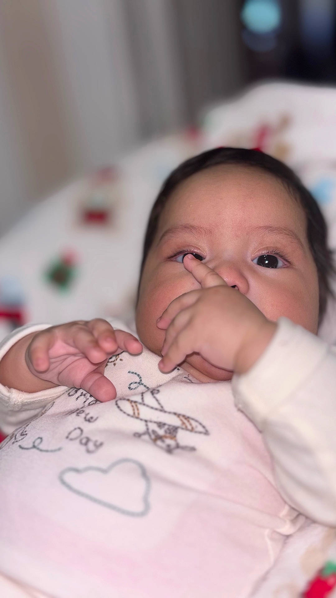 Ailany is registered to the contest to win money with this photo: baby, baby_garment, child, close_up, clothing, cute, expression, face, hand, indoors, infant, lying_down, newborn, person, playful, portrait, skin, sleepwear, soft_focus, young