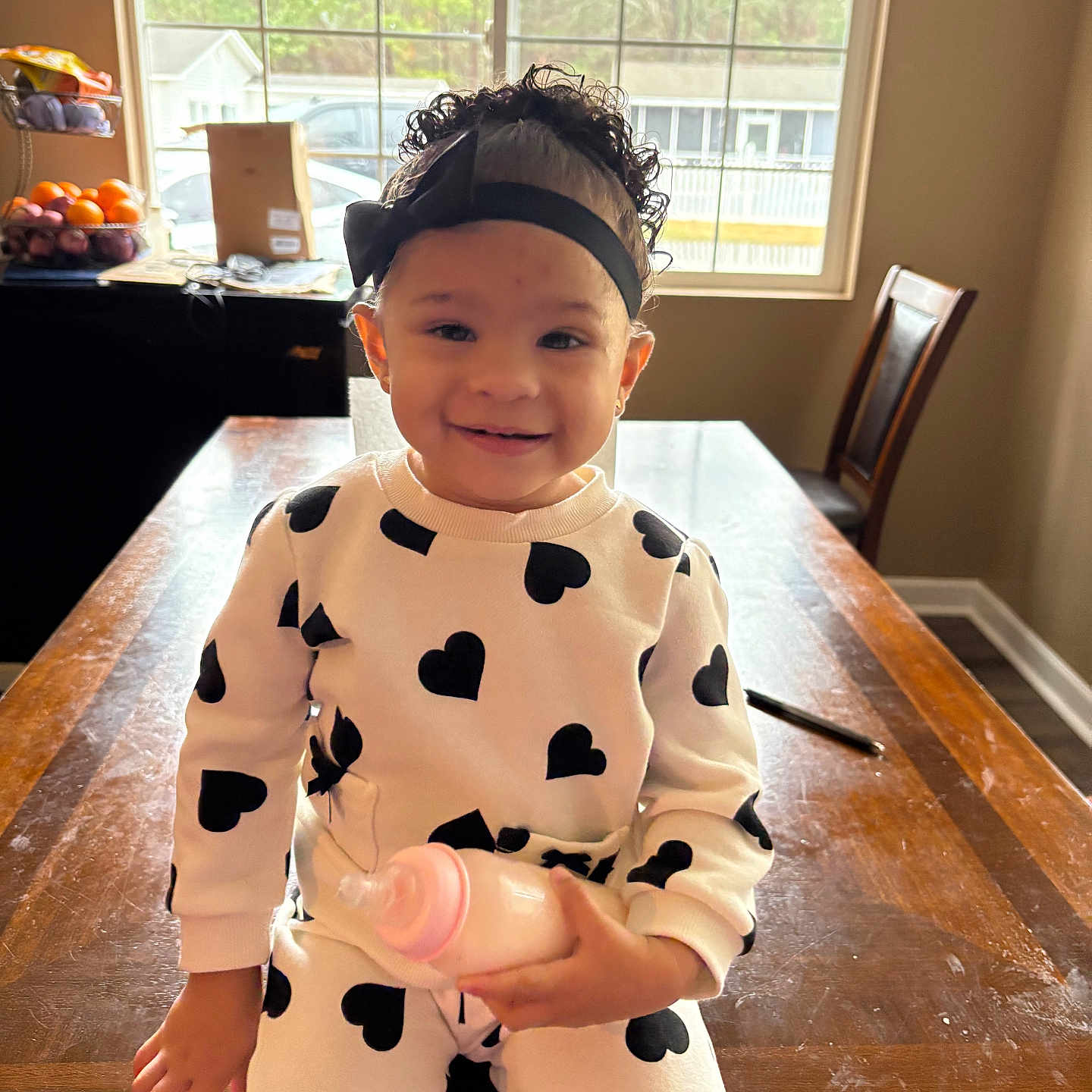 Samantha is registered to the contest to win money with this photo: architecture, baby, bodypart, building, chair, diningroom, diningtable, face, finger, furniture, hand, hardwood, head, indoors, person, photography, portrait, room, table, wood