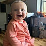Lawson joined the competition — help win amazing prizes! baby, child, smiling, orange_striped_clothing, onesie, wooden_countertop, kitchen, blender, water_bottle, window, natural_light, happy, sitting, indoor, portrait, cute, infant, face, human, home