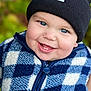 Carson is registered to the contest to win money with this photo: baby, child, smiling, face, blue_eyes, beanie, hat, fleece, vest, checkered_pattern, zipper, outdoor, portrait, happy, cute, warm_clothing, closeup, infant, person, cozy
