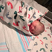 Zander is registered to the contest to win money with this photo: newborn, baby, hospital, blanket, footprints, bed, medical, infant, wrapped, sleeping, child, person, closeup, healthcare, newborn_baby, cute, fresh, skin, head, peaceful