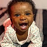 Thalia joined the competition — help win amazing prizes! baby, child, infant, smiling, happy, laughing, portrait, face, eyes, open_mouth, curly_hair, pajamas, clothing, seated, indoor, close_up, joyful, cozy, photography, person