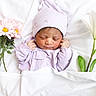 newborn, baby, sleeping, portrait, lavender, hat, onesie, blanket, flowers, daisy, lily, white_background, bed, indoor, peaceful, infant, face, closed_eyes, floral_arrangement, photography