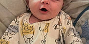 Finley is registered to the contest to win money with this photo: baby, infant, onesie, winnie_the_pooh, blanket, cute, child, smiling, clothing, soft, lying_down, pattern, face, happy, indoors, comfort, sleepwear, young_child, cozy, expression