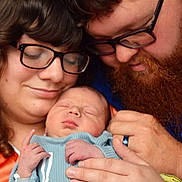 Timothy is registered to the contest to win money with this photo: baby, newborn, sleeping, couple, glasses, beard, woman, man, love, family, hands, closeup, portrait, tenderness, affection, indoor, clothing, human, skin, head