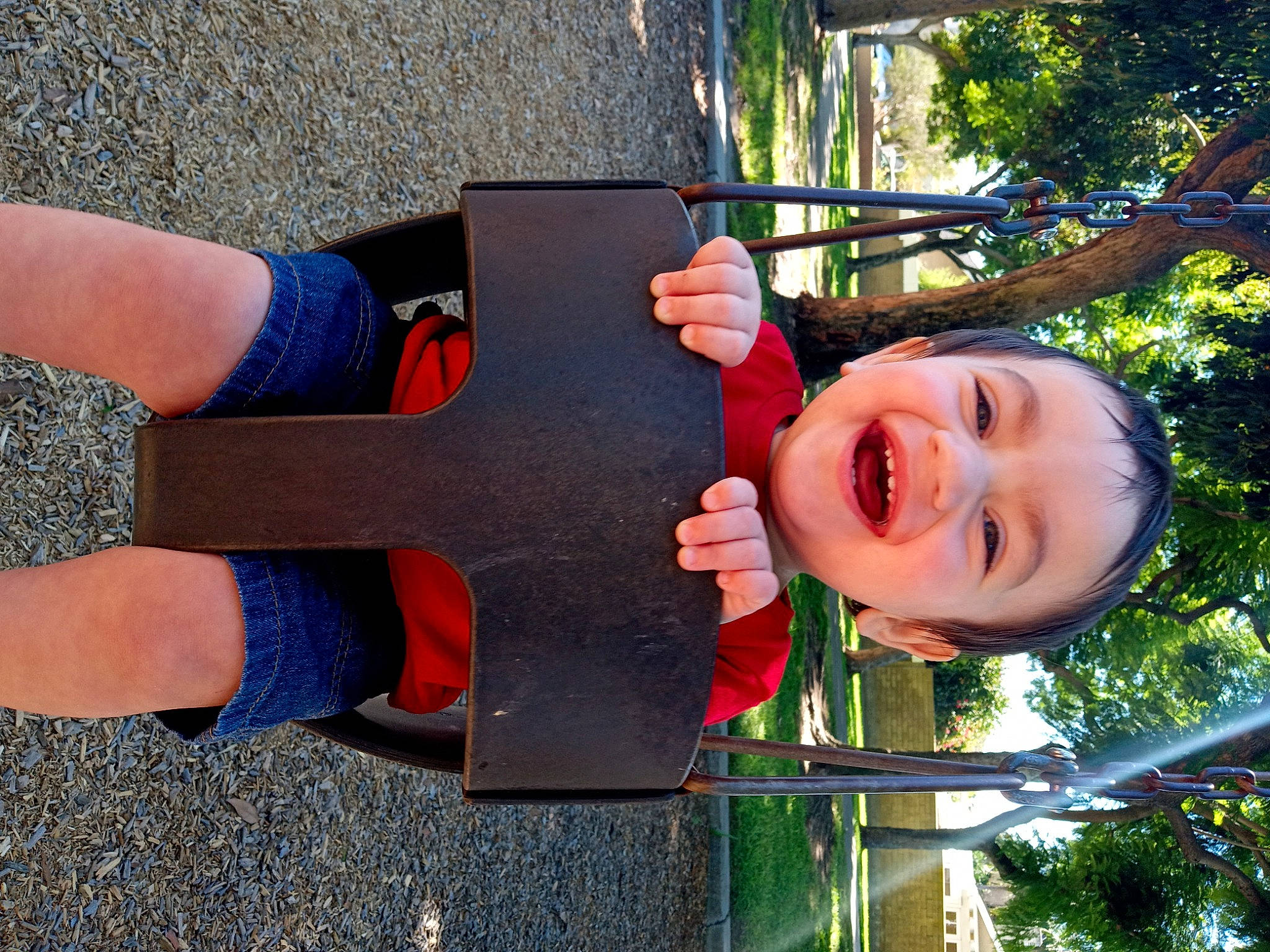 Jesse is registered to the contest to win money with this photo: calf, city, electric_blue, finger, fun, gesture, grass, happy, human_leg, joy, knee, leisure, outdoor_play_equipment, person, public_space, recreation, smile, thigh, thumb, toddler