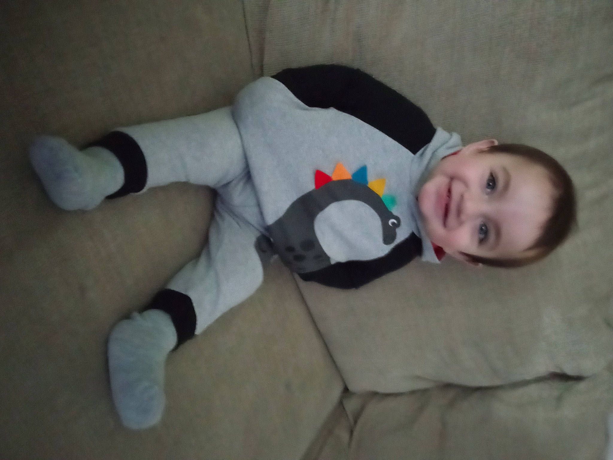 Jesse is registered to the contest to win money with this photo: baby_toddler_clothing, child, comfort, elbow, flooring, foot, fun, head, human_leg, joy, knee, pattern, person, room, sitting, skin, sleeve, smile, sock, thigh