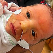 Levi joined the competition — help win amazing prizes! newborn, baby, infant, face, medical_tape, feeding_tube, hospital, closeup, eyes, skin, person, hand, blanket, healthcare, fragile, resting, cute, small, patient, care