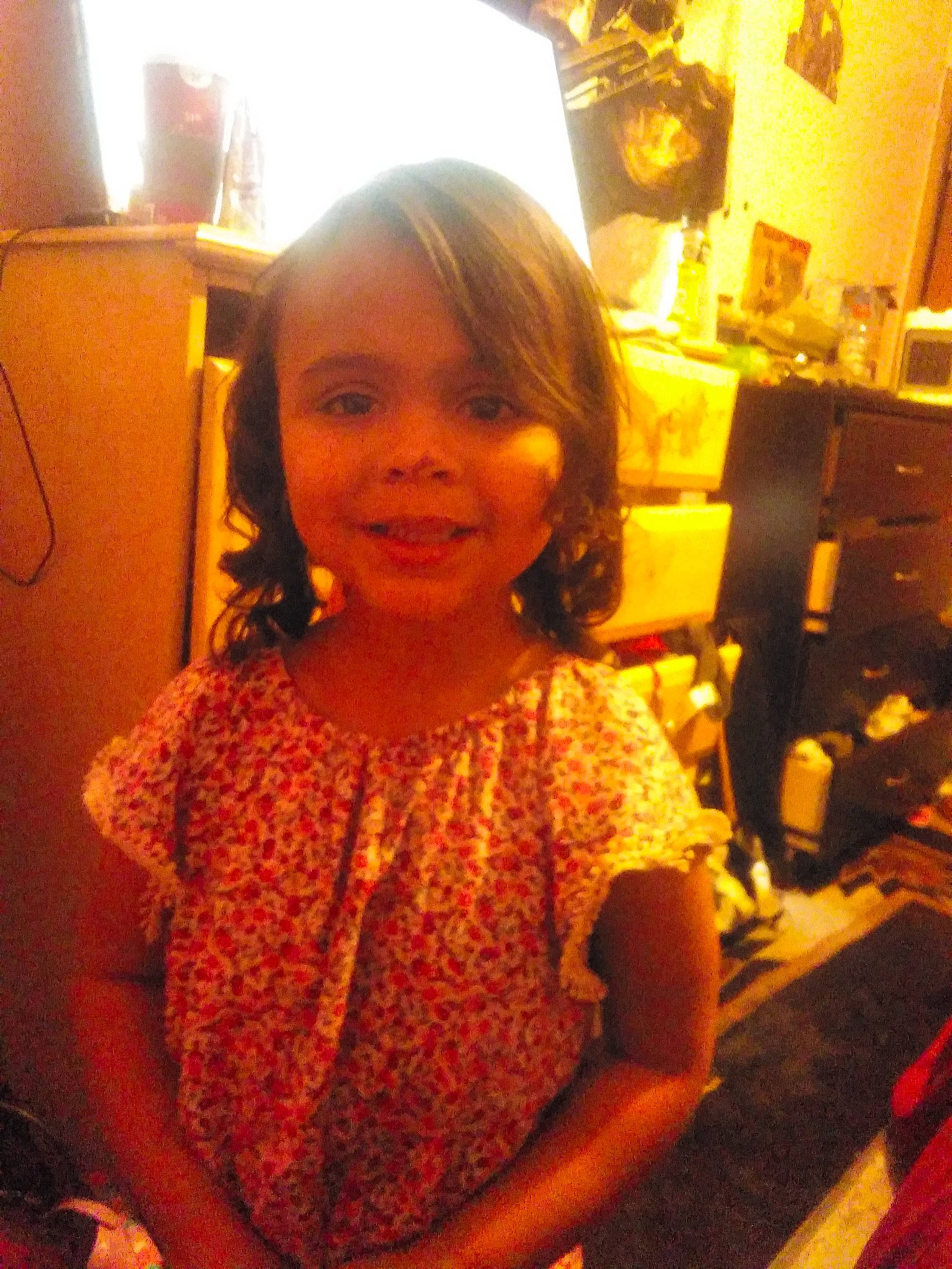 Elena is registered to the contest to win money with this photo: bangs, cheek, child, chin, event, fun, hairstyle, happy, houseplant, iris, joy, long_hair, person, room, skin, sleeve, smile, standing, t_shirt, thumb