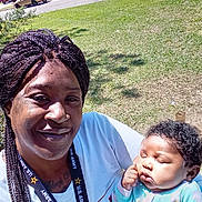 Zadie joined the competition — help win amazing prizes! baby, braided_hair, car, casual, child, clothing, daylight, face, grass, holding, house, lanyard, neighborhood, outdoor, person, portrait, relaxed, sleeping, smiling, woman