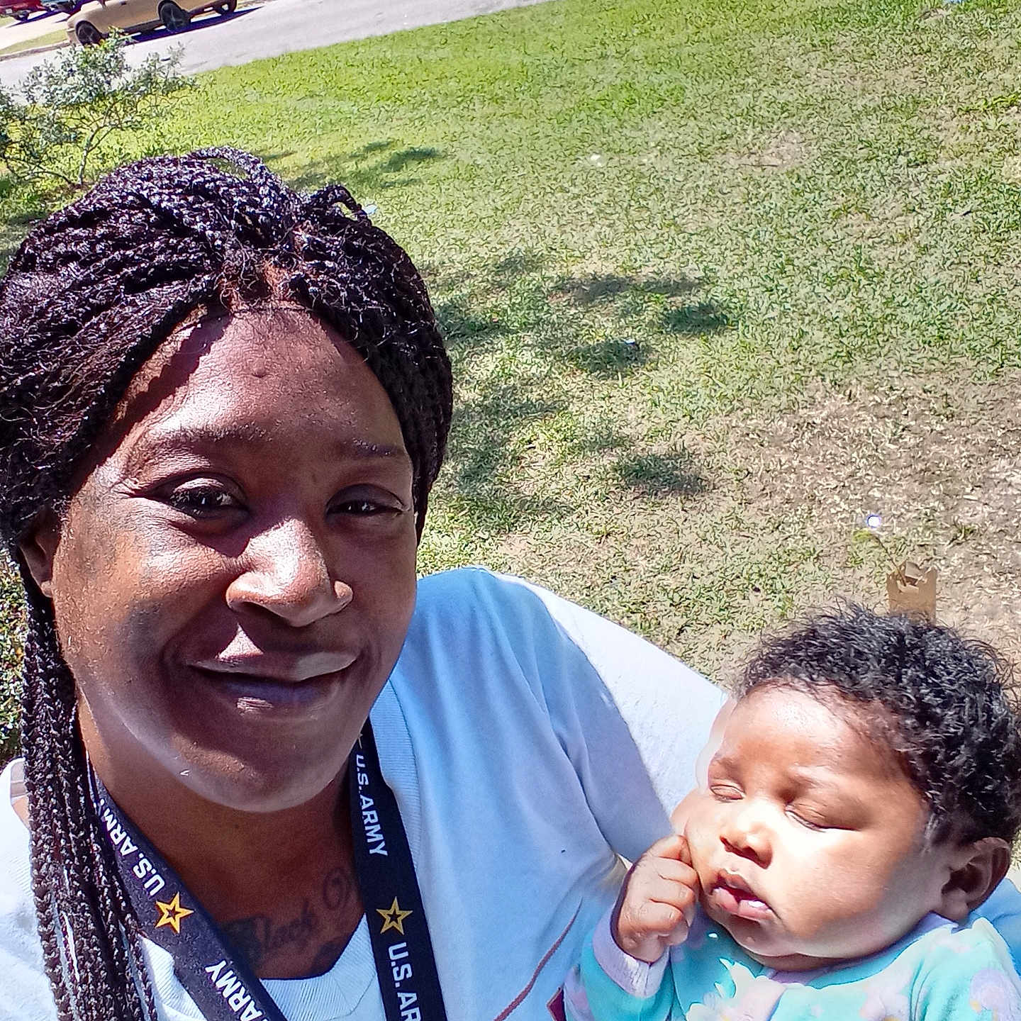 Zadie joined the competition — help win amazing prizes! baby, braided_hair, car, casual, child, clothing, daylight, face, grass, holding, house, lanyard, neighborhood, outdoor, person, portrait, relaxed, sleeping, smiling, woman