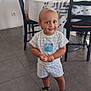 toddler, child, smiling, standing, indoor, dining_room, table, chairs, floor, tile, clothing, shoes, cute, person, young_child, home, decor, happy, portrait, casual