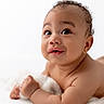 baby, infant, child, cute, portrait, face, skin, eyes, smile, curly_hair, lying_down, soft_light, white_background, hands, expression, closeup, adorable, newborn, innocence, young_child