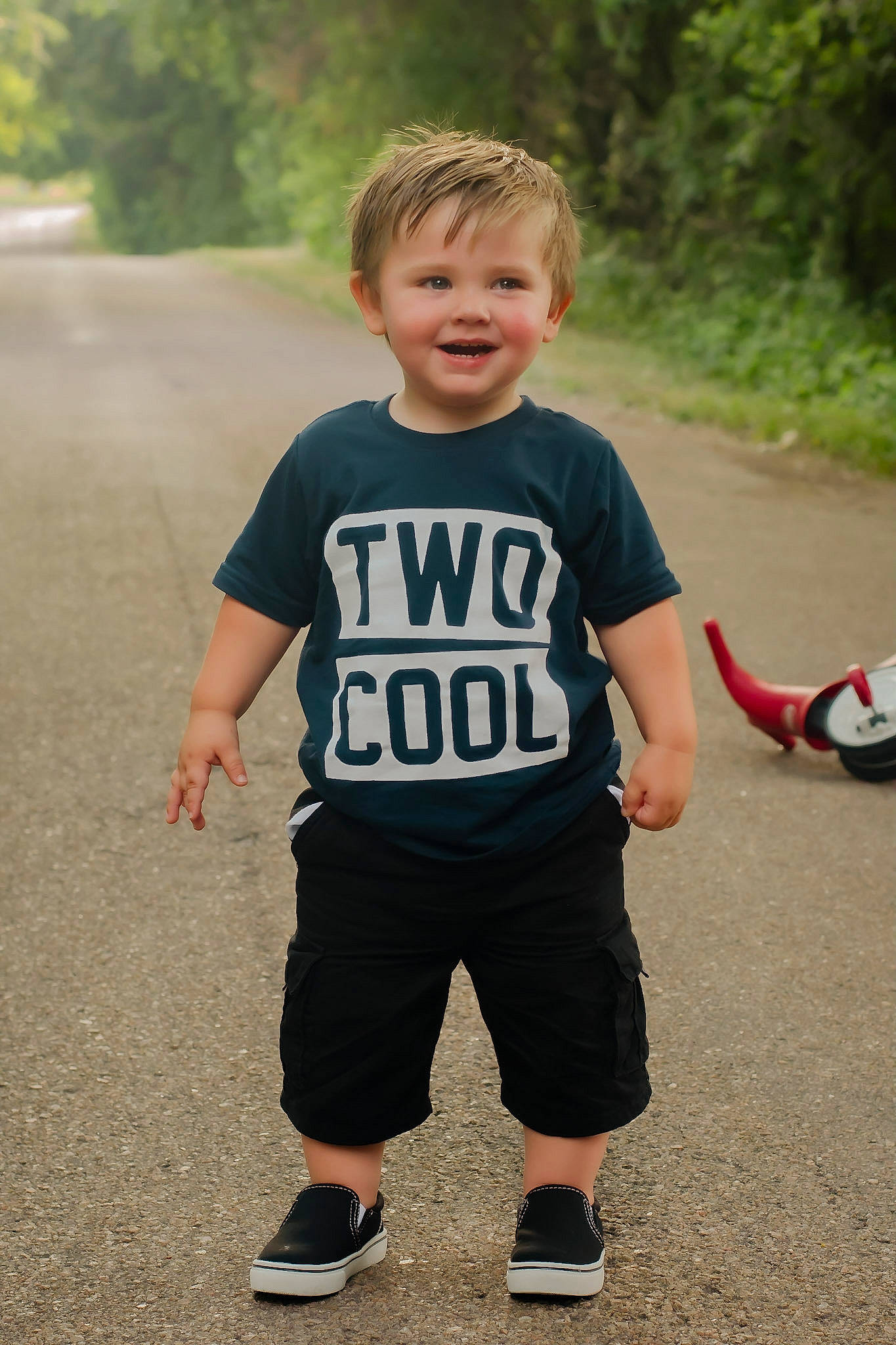 Holden is registered to the contest to win money with this photo: arm, asphalt, baby_toddler_clothing, child, fun, grass, happy, joint, joy, leisure, pattern, person, recreation, road, shorts, sleeve, smile, sportswear, standing, t_shirt