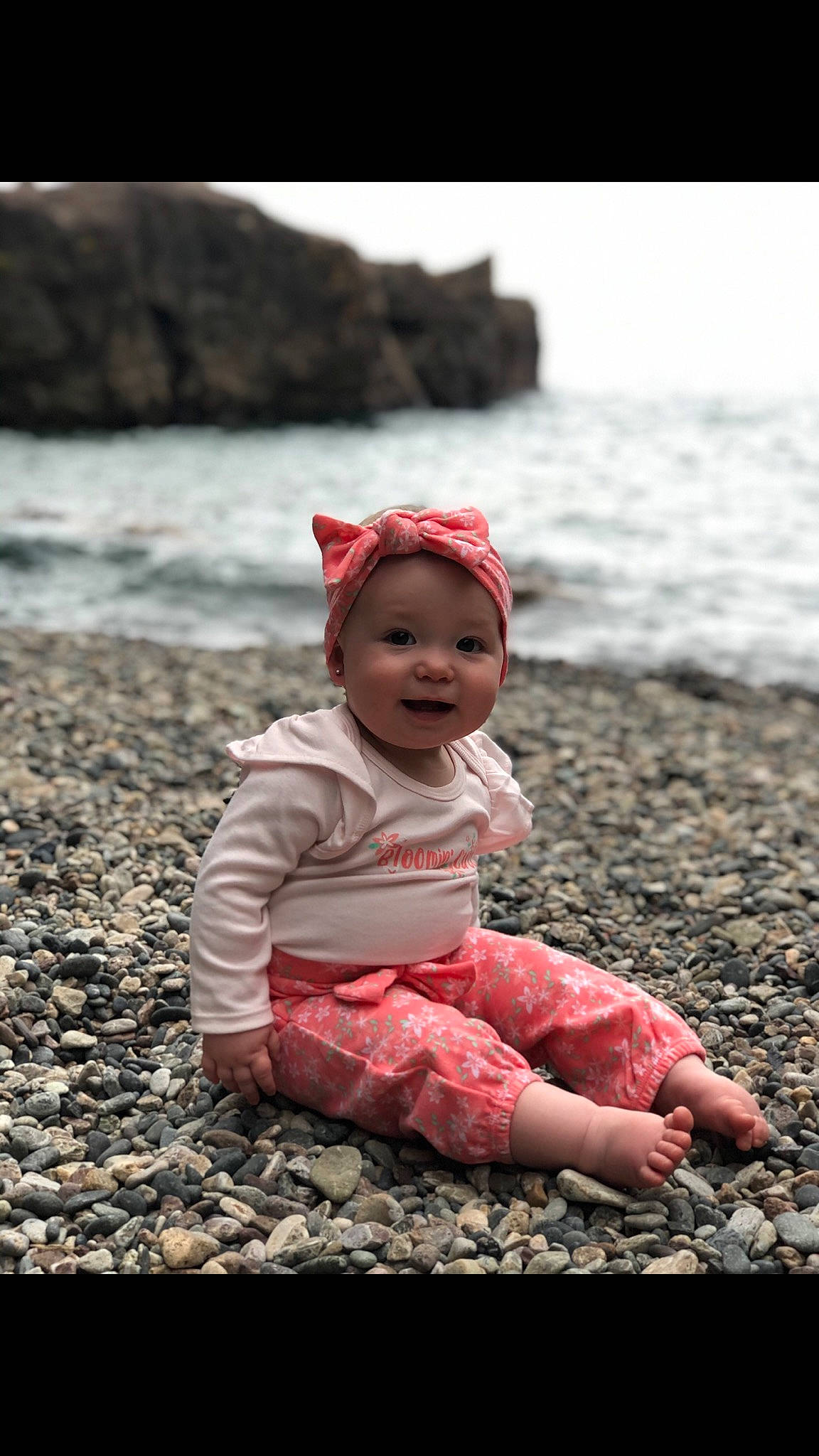 Amarah joined the competition — help win amazing prizes! baby, baby_toddler_clothing, beach, beauty, cap, child, coast, coastal_and_oceanic_landforms, flash_photography, grass, happy, headwear, lake, landscape, morning, people_in_nature, person, rock, sitting, toddler