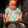 Brooklyn joined the competition — help win amazing prizes! baby, child, toddler, stroller, floral_dress, pink_bow, smiling, happy, infant, seat, black_stroller, cute, young_child, portrait, indoors, person, baby_girl, colorful_clothing, sitting, curious