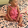 Brooklyn joined the competition — help win amazing prizes! bed, blanket, child, curly_hair, cute, earring, foot, furniture, hand, home, indoor, leopard_print, person, pink, portrait, romper, sitting, striped_clothing, toddler, young_child