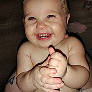 Molly is registered to the contest to win money with this photo: baby, child, smiling, clapping, hands, teeth, face, skin, diaper, happy, indoor, flash, closeup, cute, infant, person, expression, light, cheeks, eyes