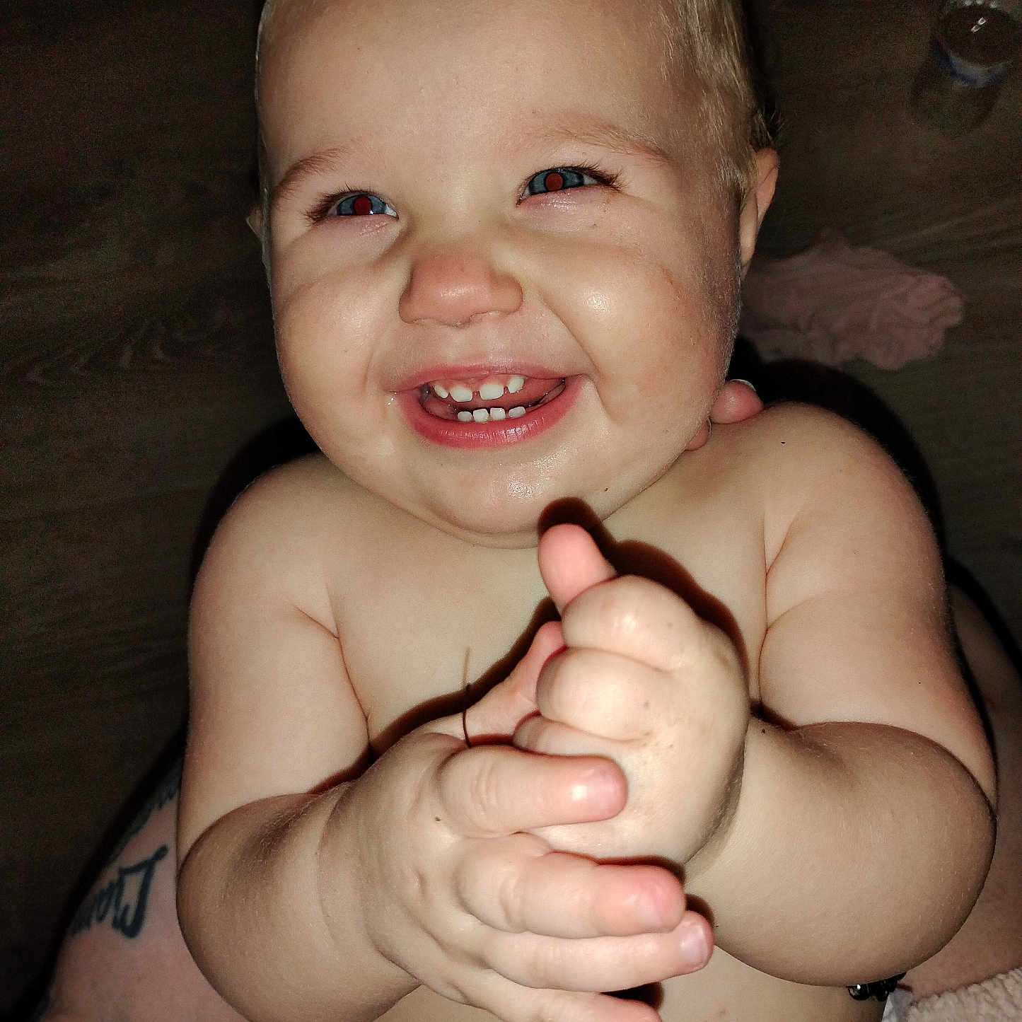 Molly is registered to the contest to win money with this photo: baby, child, smiling, clapping, hands, teeth, face, skin, diaper, happy, indoor, flash, closeup, cute, infant, person, expression, light, cheeks, eyes