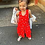 Rose a rejoint le concours — aidez-le/la à gagner de superbes lots ! child, girl, red_dress, pigtails, hair_bows, white_jacket, outdoor, sidewalk, smiling, playful, standing, casual_shoes, concrete, building, door, daylight, cute, happy, young, fashion