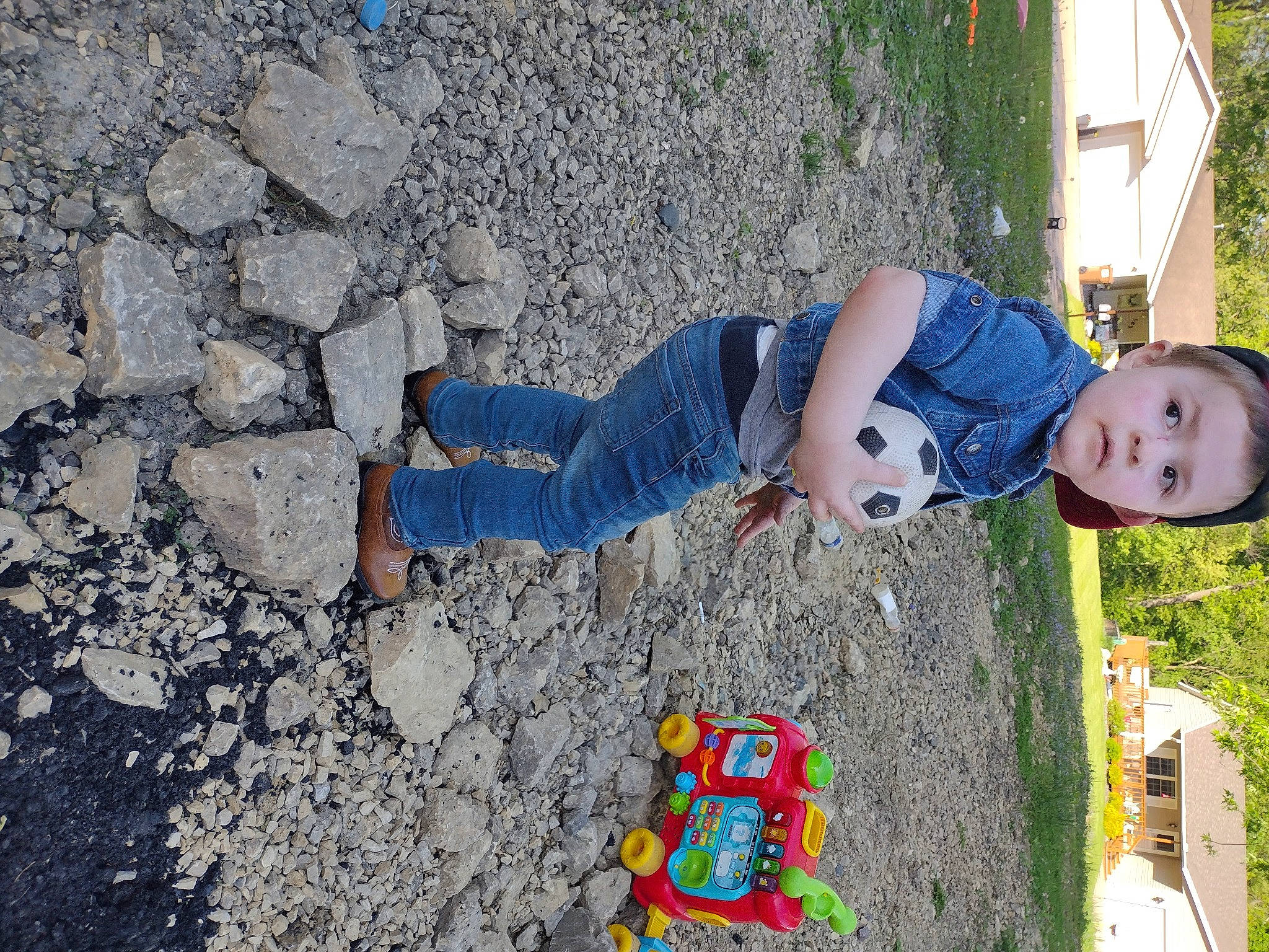 Colton is registered to the contest to win money with this photo: asphalt, child, concrete, denim, electric_blue, fun, grass, human_leg, human_settlement, landscape, leisure, people_in_nature, person, plant, play, public_space, recreation, road_surface, sidewalk, soil
