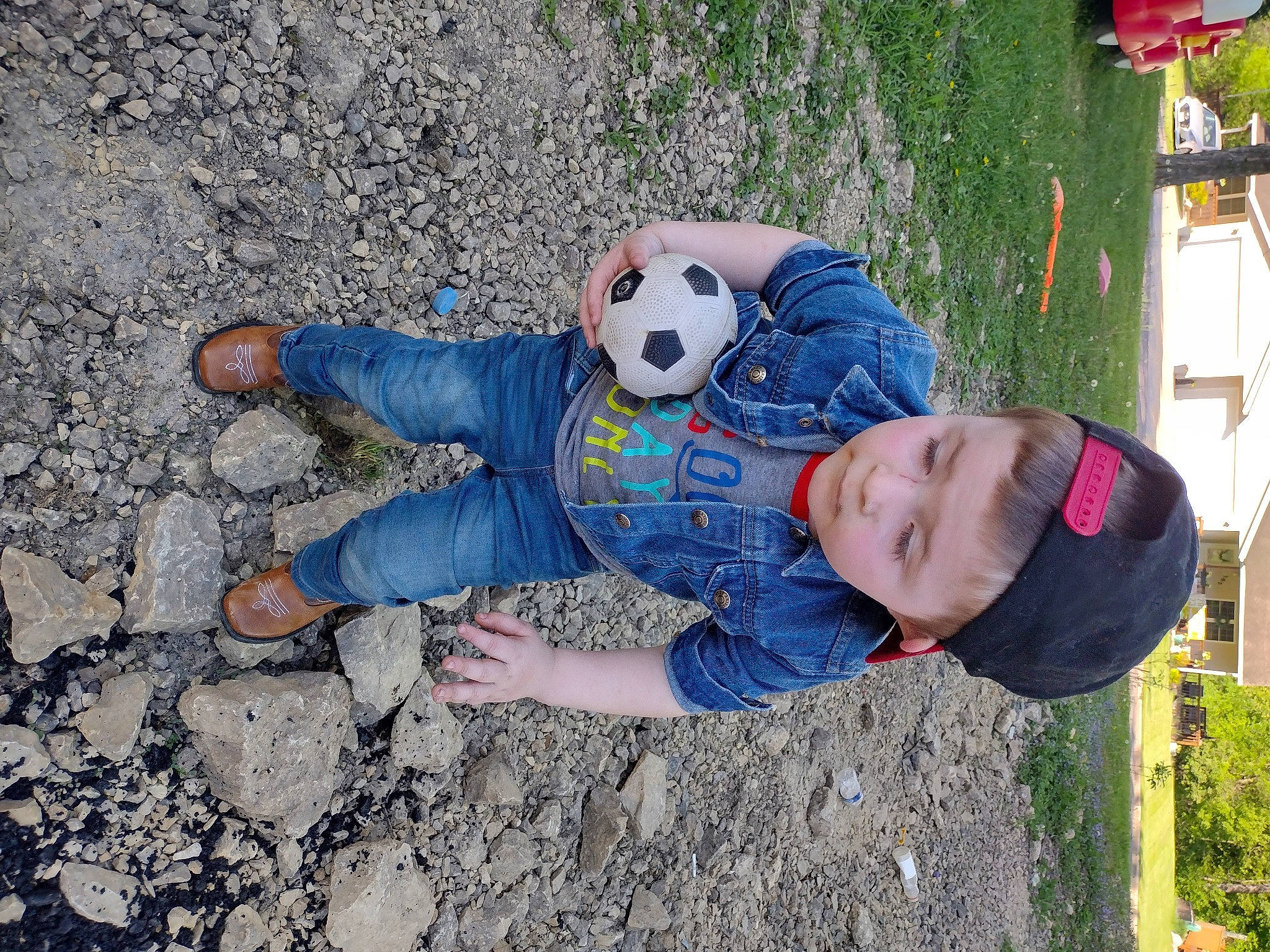 Colton joined the competition — help win amazing prizes! adventure, ball, child, football, fun, grass, happy, leisure, people_in_nature, person, plant, play, public_space, recreation, road_surface, sitting, soil, t_shirt, toddler, toy