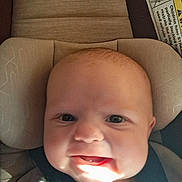 Dustin is registered to the contest to win money with this photo: baby, infant, car_seat, child, smiling, face, seatbelt, head_support, happy, closeup, indoors, person, young_child, cute, skin, light, shadow, clothing, safety, expression