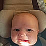 baby, infant, car_seat, child, smiling, face, seatbelt, head_support, happy, closeup, indoors, person, young_child, cute, skin, light, shadow, clothing, safety, expression