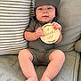 Stetson Hayes joined the competition — help win amazing prizes! baby, infant, child, couch, pillow, wooden_sign, hat, clothing, sitting, legs, feet, hands, face, expression, home, indoor, fabric, striped_pillow, cute, comfortable