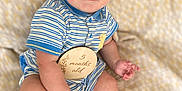 Stetson Hayes is registered to the contest to win money with this photo: baby, infant, child, striped_clothing, blue, onesie, plaque, 5_months_old, milestone, sitting, blanket, soft_texture, smile, cute, portrait, hand, foot, skin, indoor, closeup